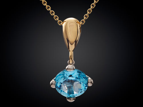 18 karaat geelgouden collier met hanger witgoud en blauw topaas edelsteen van Marijke Mul danser collectie